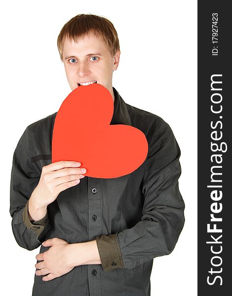 Young caucasian man bite red paper heart isolated