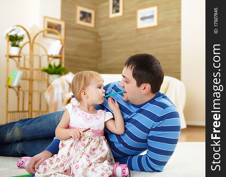 Father with his little daughter at home