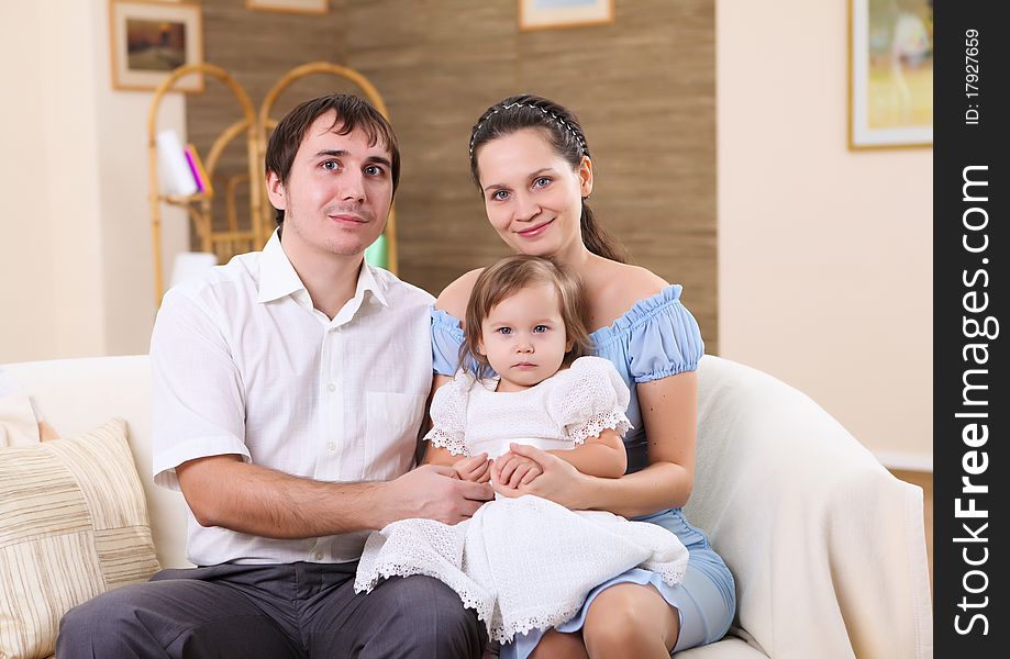 Young family at home with a daughter