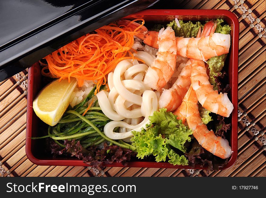 Traditional Japanese cuisine in a box with seafood and vegetables