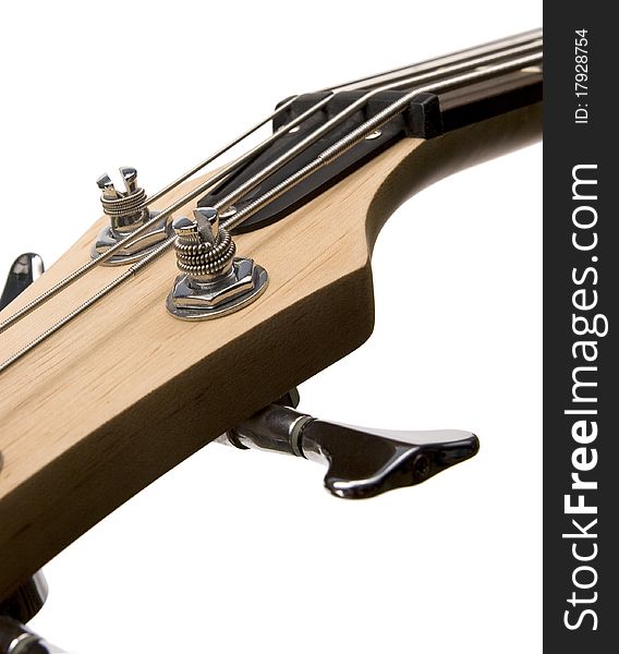 Bass guitar fingerboard head with stainless metal pins for tuning strings and strained strings. Bass guitar fingerboard head with stainless metal pins for tuning strings and strained strings