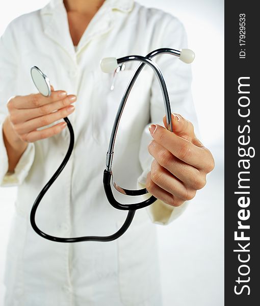 Nurse standing and giveing away her stethoscope. Nurse standing and giveing away her stethoscope