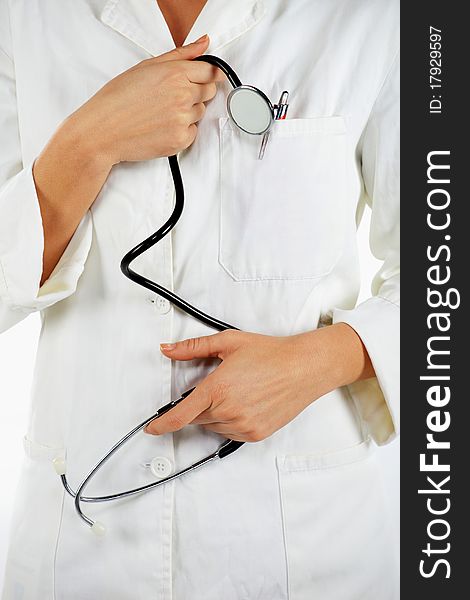 Detail of nurse standing and holding the stethoscope. Detail of nurse standing and holding the stethoscope