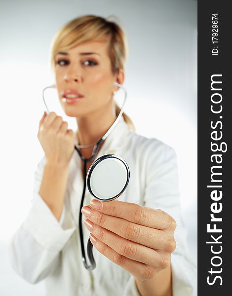 Nurse with the stethoscope in her hand ready to work with the patient. Nurse with the stethoscope in her hand ready to work with the patient