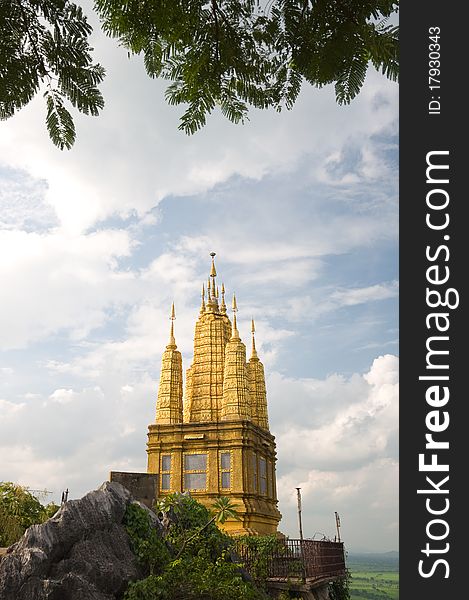 Old golden pagoda on mountain at Ratchaburi province Thailand