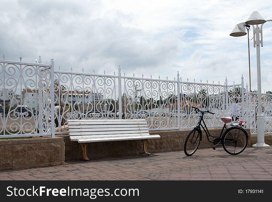 White bench and bike in the park