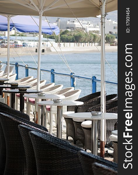 Tables and chairs on the background of the sea and mountains