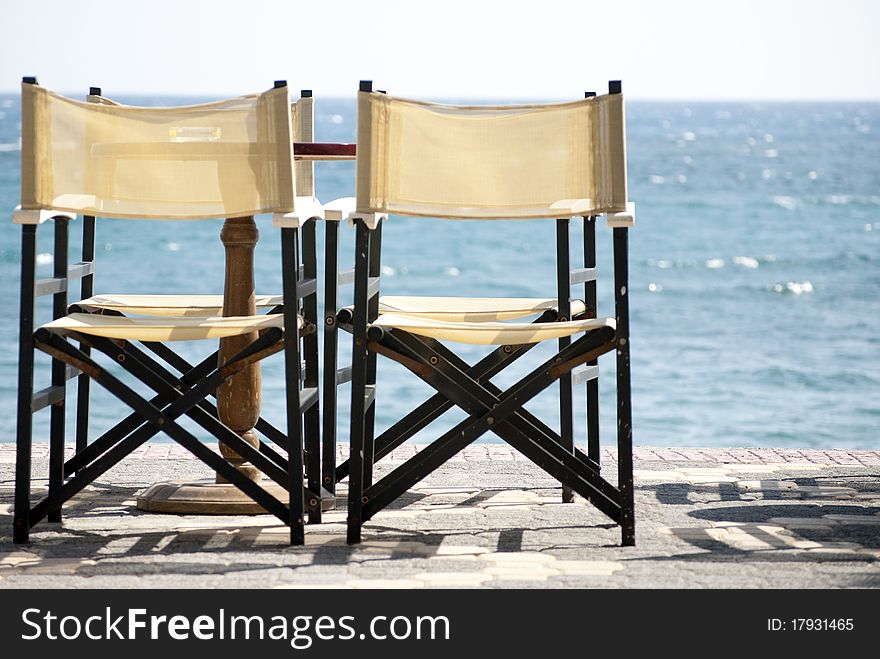 Tables and chairs on the background of the sea