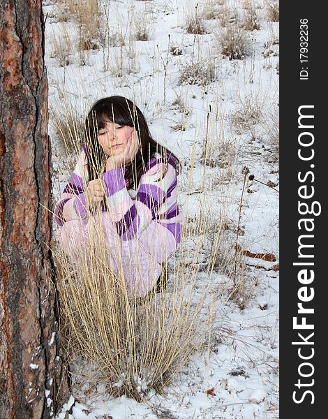 Young brunette teen playing in the field after the snowfall. Young brunette teen playing in the field after the snowfall