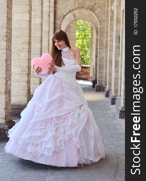 Bride with a pink heart in the hands. Bride with a pink heart in the hands