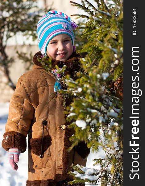 Beautiful girl near firtree outdoor in winter. Beautiful girl near firtree outdoor in winter