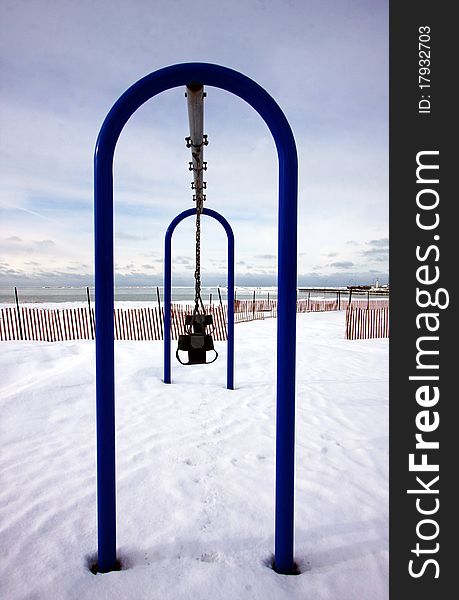 An empty playground by the lake in the winter