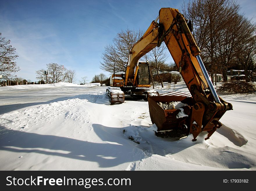 A yellow tractor in the snow. A yellow tractor in the snow