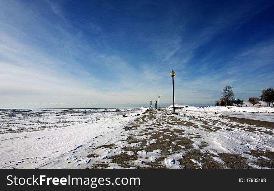 A snow-covered pier by the lake