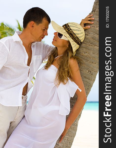 Happy young couple on a tropical beach. Happy young couple on a tropical beach