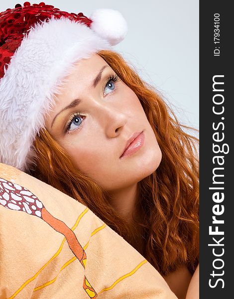 Beauty red woman in santa hat - portrait