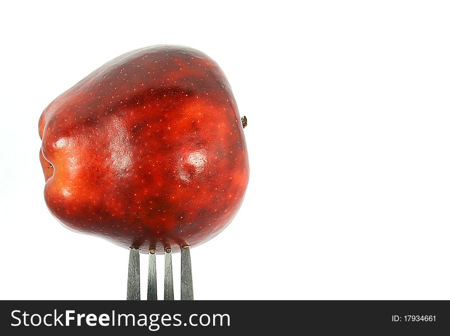 Fork with a red apple. Fork with a red apple