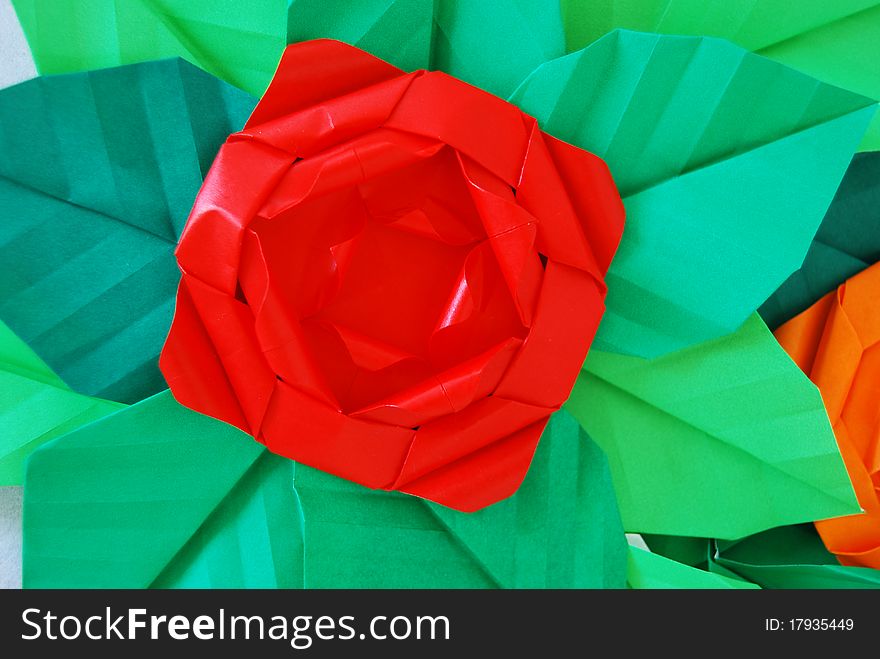 Paper flower, or origami folded and shaped in rose. Paper flower, or origami folded and shaped in rose
