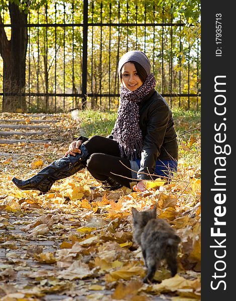 Young girl with a cat outdoors