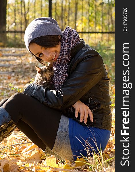 Young Girl With A Kitty Outdoors