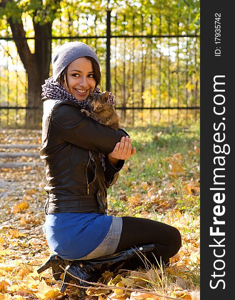 Young girl with a kitty outdoors