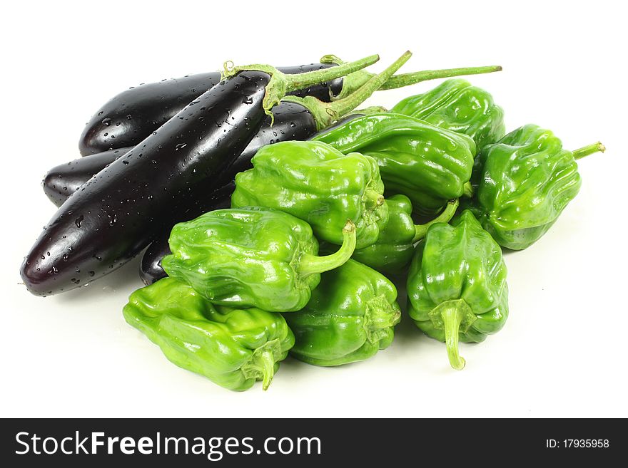 Green peppers and purple eggplant on white background