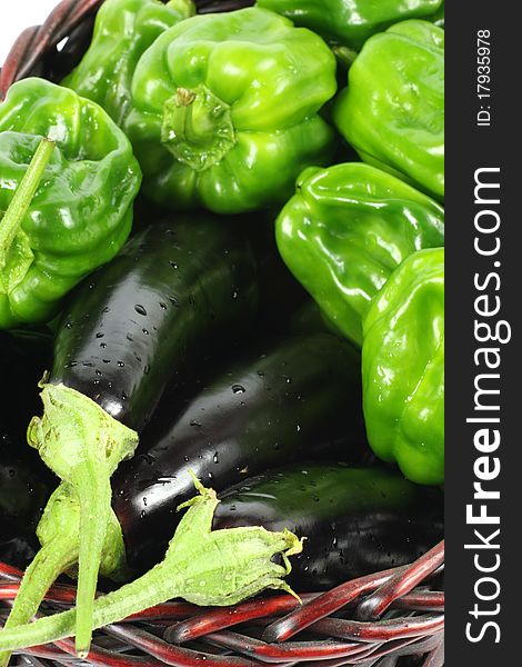 Green peppers and purple eggplant on white background