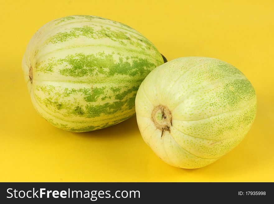 Two melon on yellow background