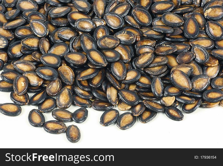 Black melon seeds on white