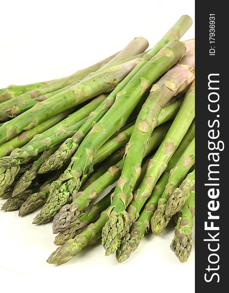A pile of asparagus on a white background