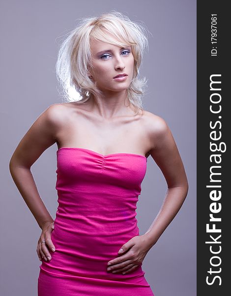 Attractive blond girl in pink dress. Attractive blond girl in pink dress