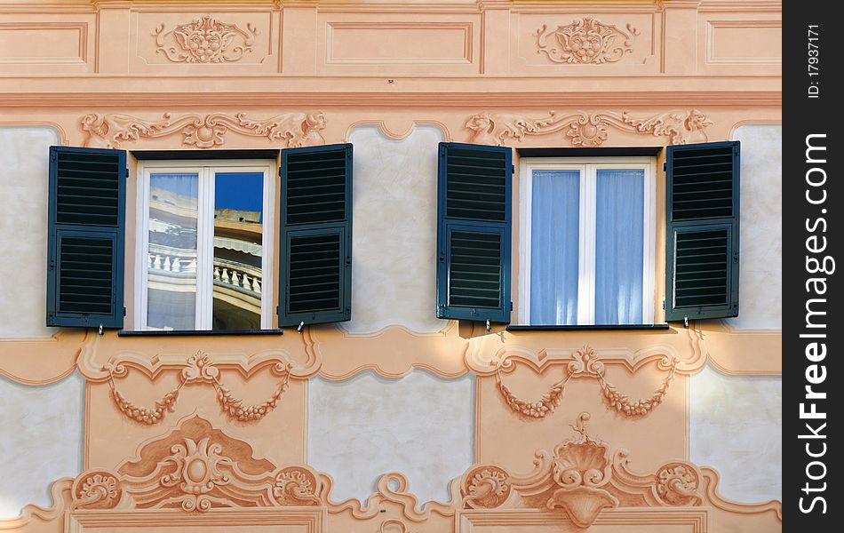 Decorated windows on a facade in Genoa