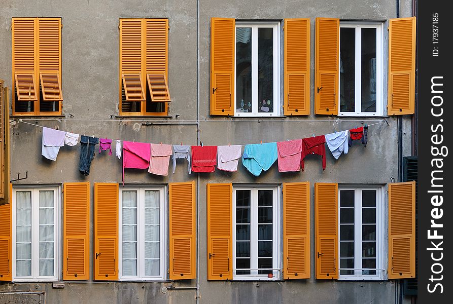 Windows with clothes hanging in the streets of Genoa