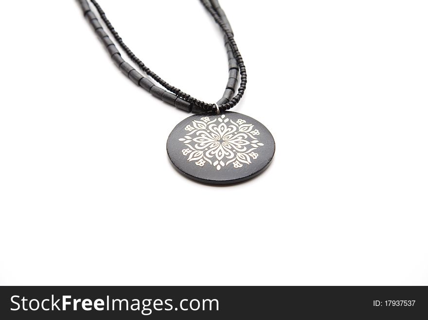 Black necklace with pattern onto white background