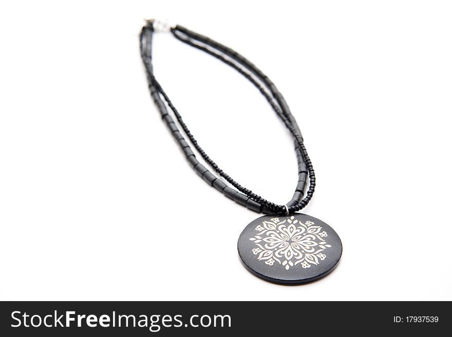 Black necklace with pattern onto white background