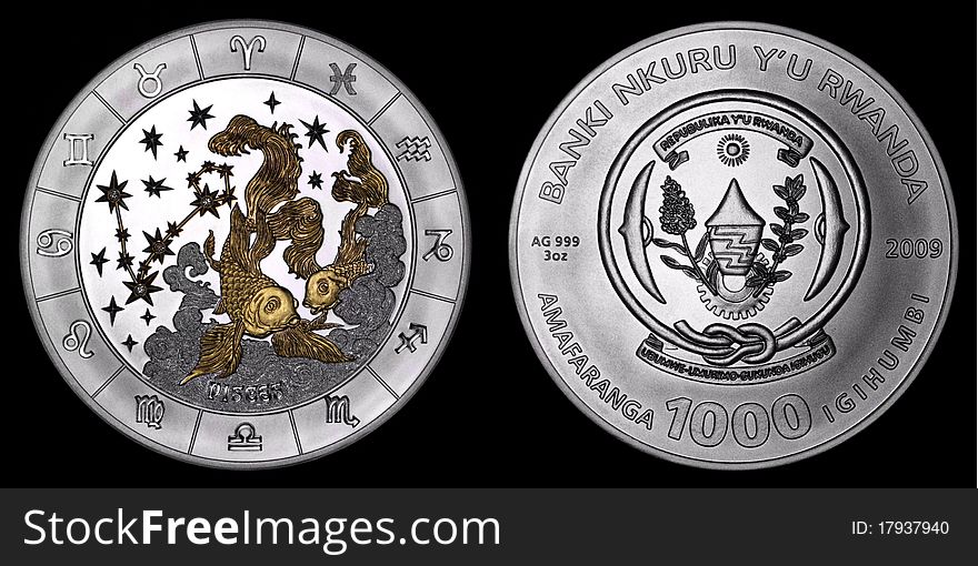 Silver coin depicting the signs of the zodiac, diamonds, and a picture of pisces