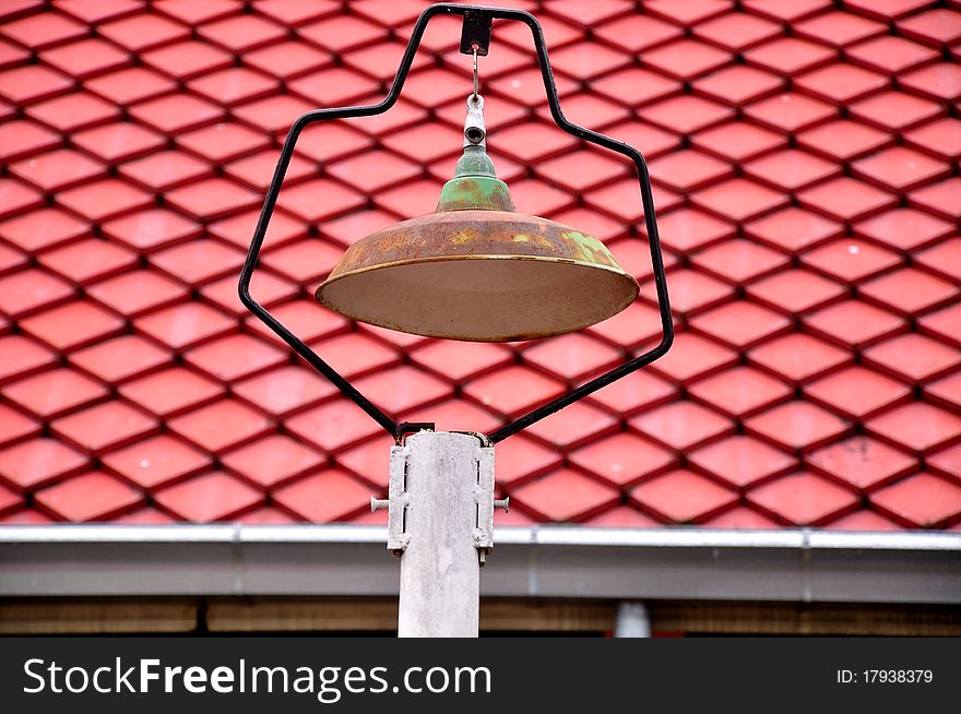 Street lamp on sunset and roof