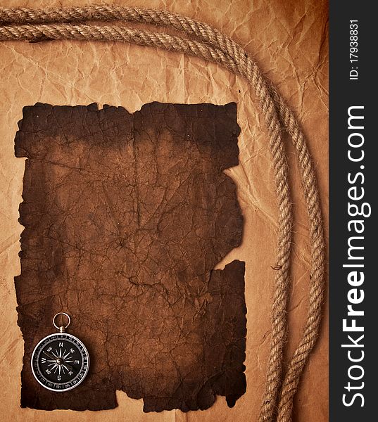 Old paper, compass and rope on grunge background