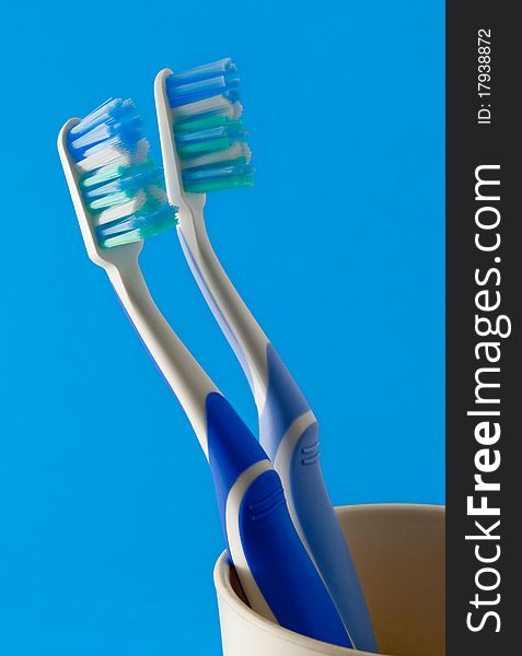 Toothbrushes in a plastic cup