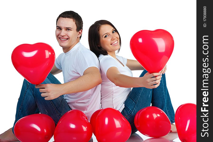 Young couple with a hearts over white background