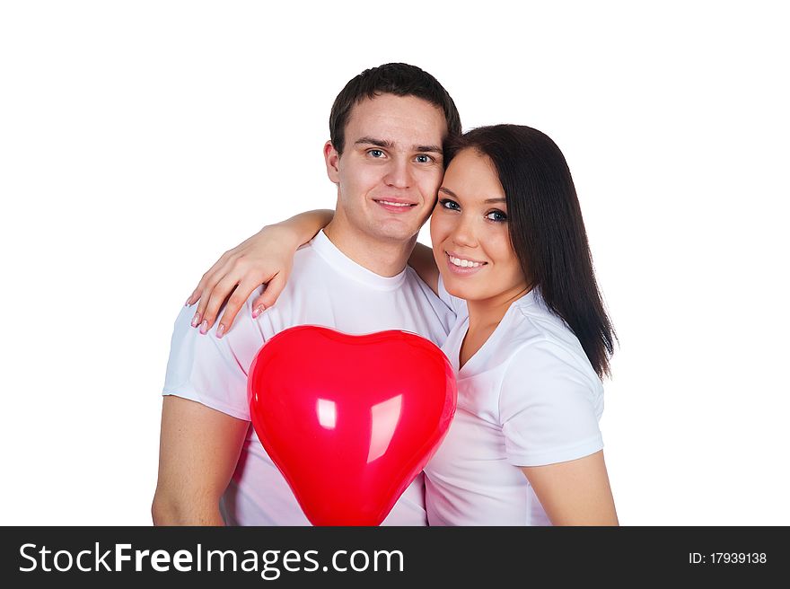 Young couple with a heart over white background