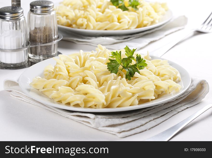 Two plates of pasta with parsley