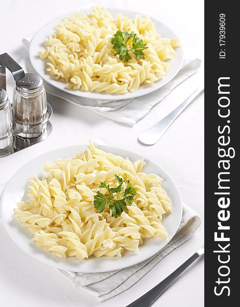 Two plates of pasta with parsley