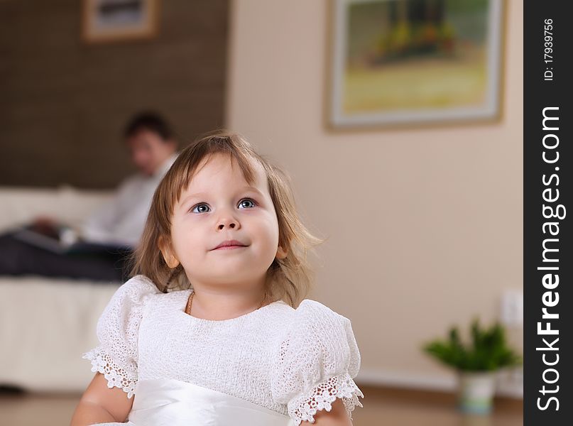 Little girl playing on the floor at home