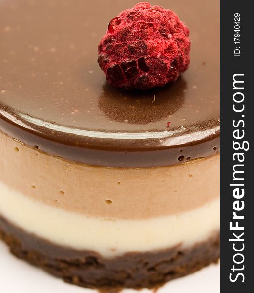 Cake of chocolate with cream and strawberrie isolated on white close-up