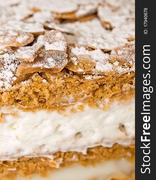 Cake almond with whipped cream and cream isolated on white close-up