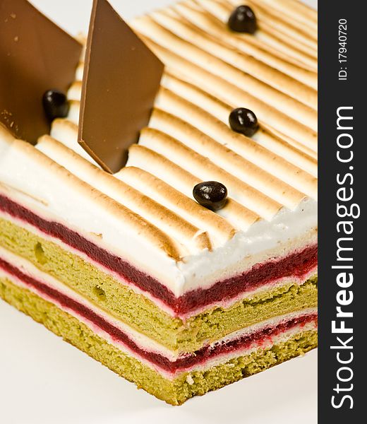Cake pistachio, strawberries and cream close-up