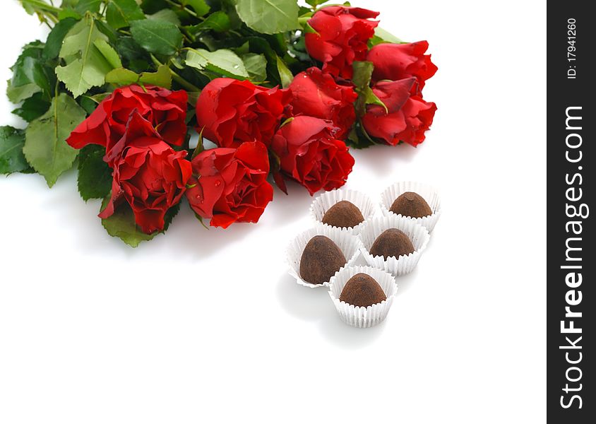 Bunch of red roses and heart-shaped gift with chocolate for St.Valentine's Day. Bunch of red roses and heart-shaped gift with chocolate for St.Valentine's Day