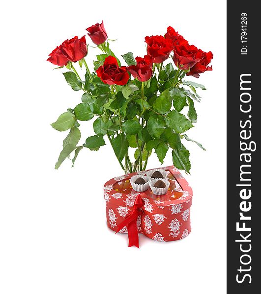 Bunch of red roses and heart-shaped gift with chocolate for St.Valentine's Day. Bunch of red roses and heart-shaped gift with chocolate for St.Valentine's Day