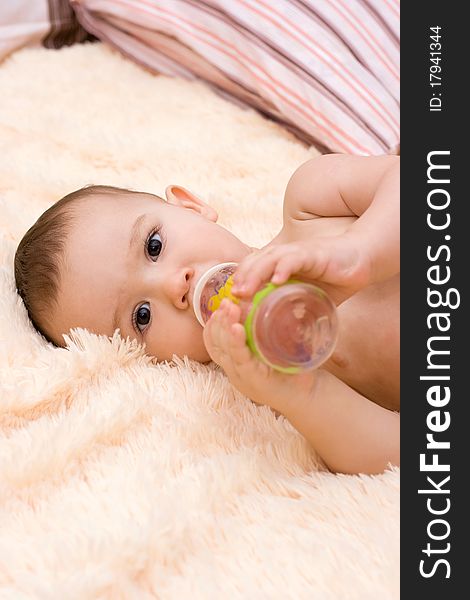 Little Caucasian Boy Drinking From The Bottle